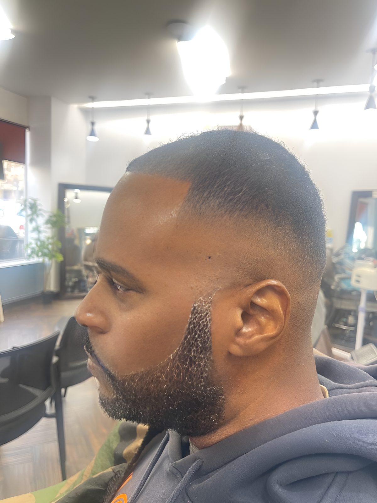 Clean fade and sculpted beard lineup by Rico