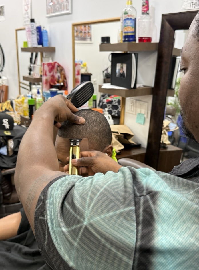 Rico doing a mid-fade in his barber chair