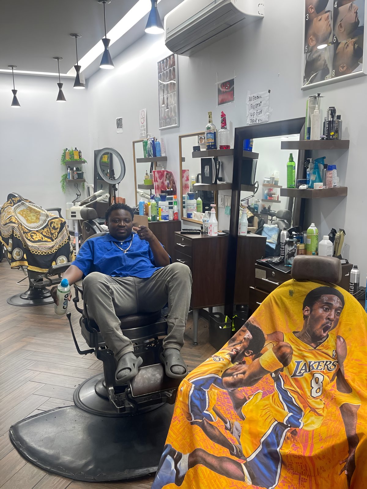 Inside Ladies & Gents: Rico seated in his barber chair between the stations