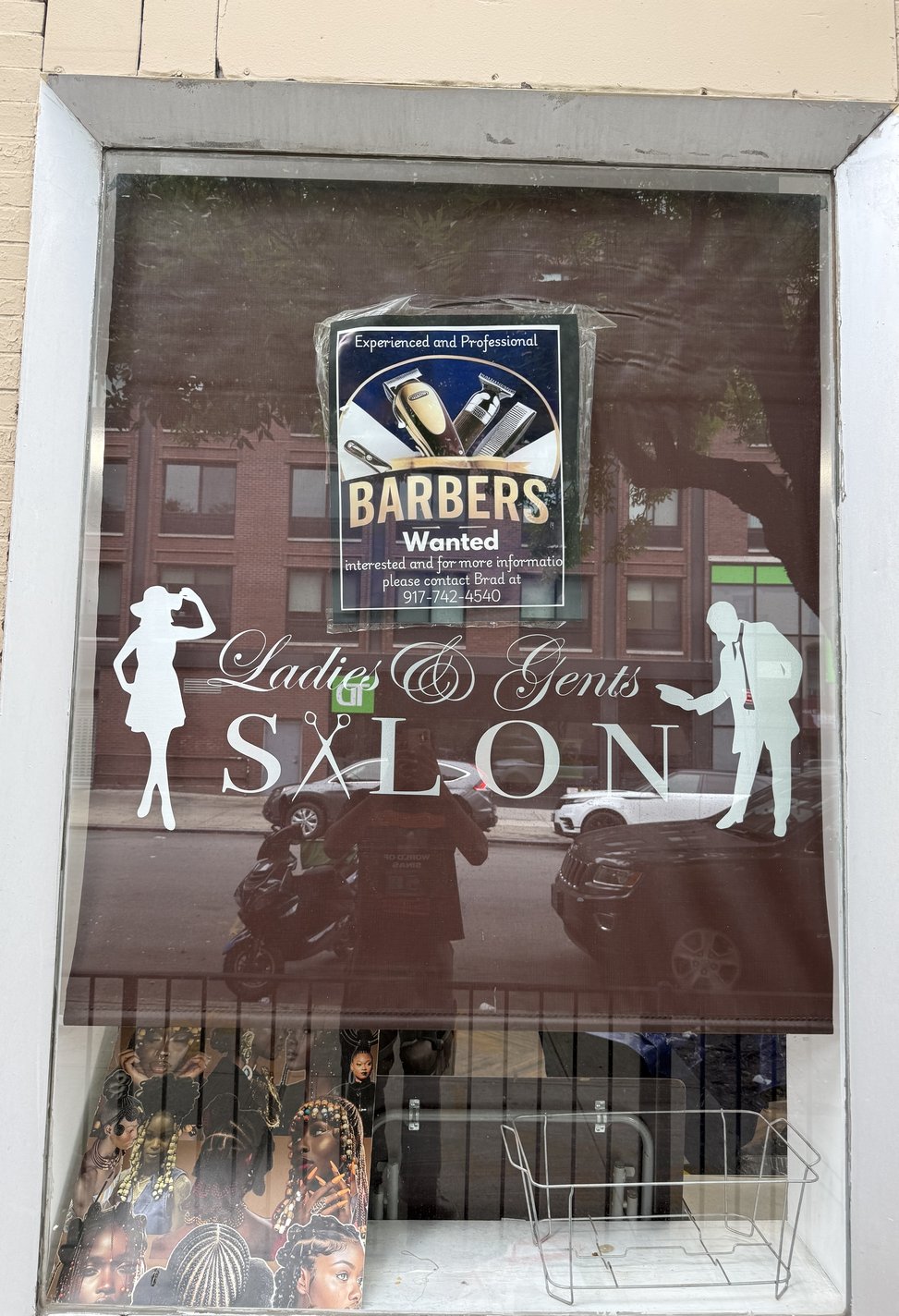 The Ladies & Gents Salon storefront on Hall Street in Brooklyn, with etched-glass signage and styling chairs visible inside.